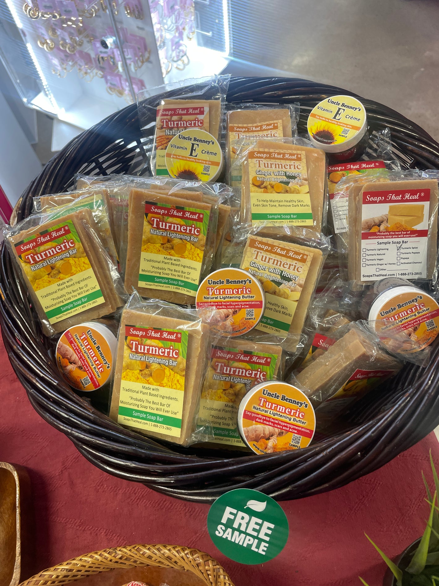 Basket of free Soaps That Heal samples featuring a variety of natural plant-based soap bars, including turmeric for dark spots, turmeric ginger with honey for natural brightening, turmeric spice for severe facial hyperpigmentation, and nourishing soaps for dry or sensitive skin