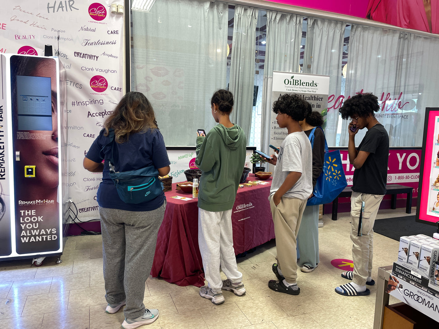 Crowd enjoying the OilBlends and Clore Beauty Supply event, browsing natural Uncle Benney's beauty products, discussing skin-loving plant-based ingredients, and getting personalized product guidance.
